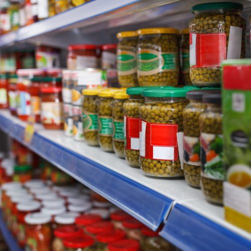 Image of different pickle goods at shelves in a food store